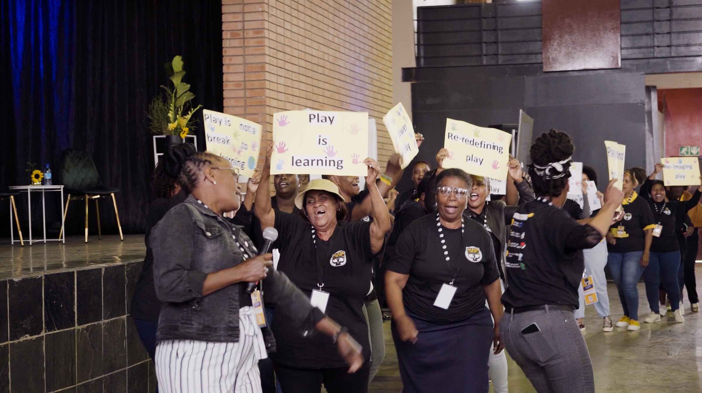 ECD educators dancing with posters